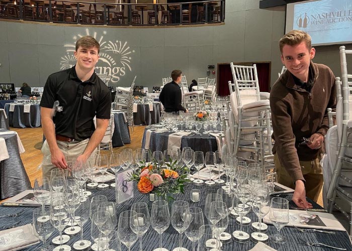 Two men setting table