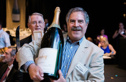 Man holding large wine bottle