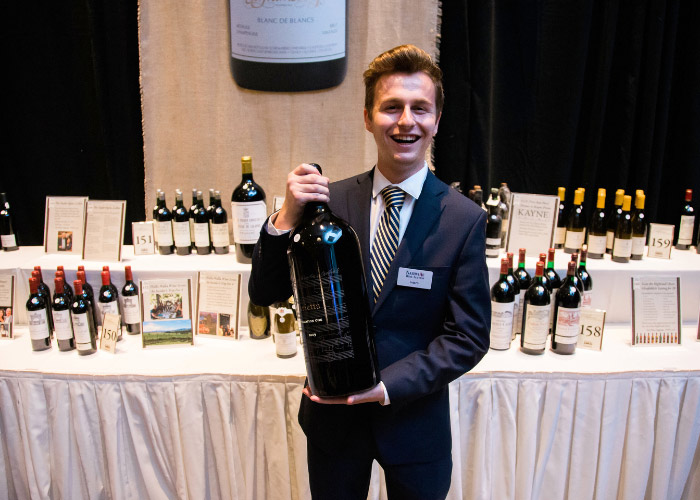 Man Holding large bottle of wine