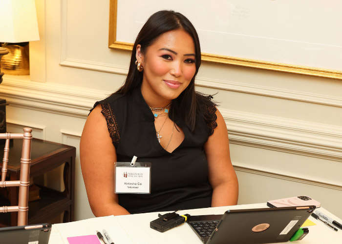 Woman Sitting at table with a laptop