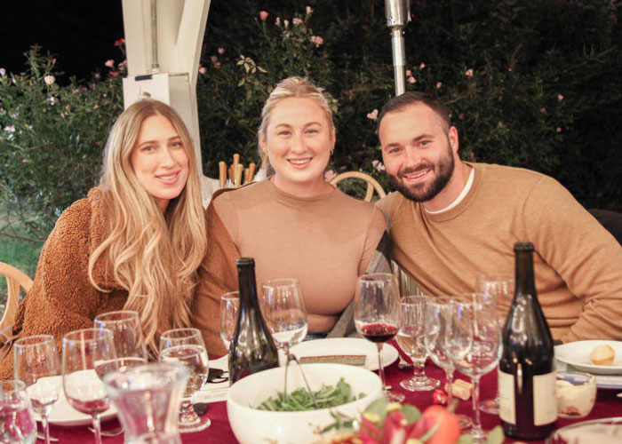 Three people sitting at dinner table